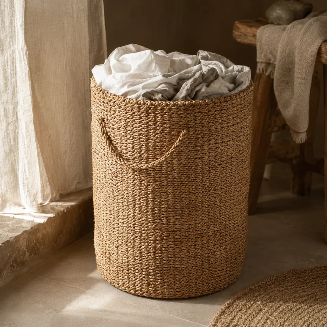 Laundry Basket Ø40 H55 — Seagrass in use, loaded, photographed in a room